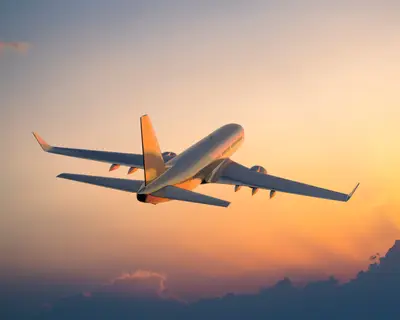 Plane flying with twilight backdrop