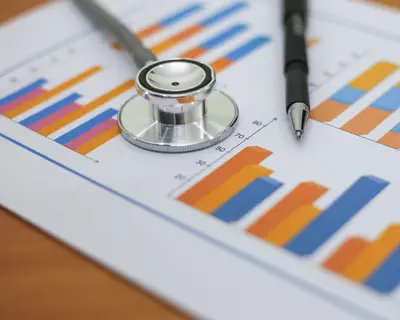 Stethoscope and pen resting on paper with charts