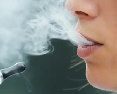 Closeup of a young woman using an electronic cigarette