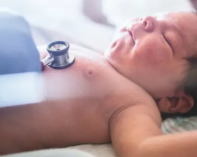 A newborn baby receives a medical checkup.