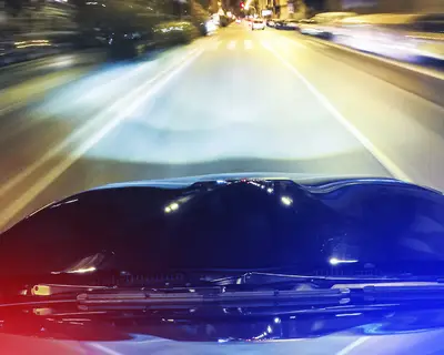 police car lights flashing at night