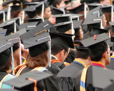 Students in caps and gowns at a graduation ceremony