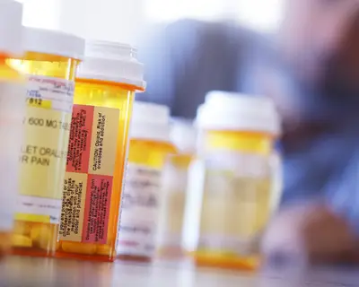 Person pictured with prescription opioids