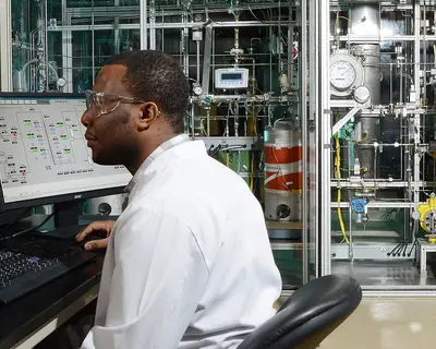 Scientist man using hydrotreater equipment
