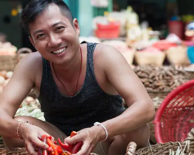 A male vendor in an Asian food market