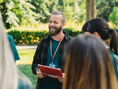 Male volunteer holds clipboard