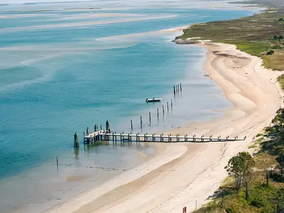 OBX, NC coastline. Blue water with shore and dock