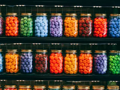 colorful circular-shaped candies in mason jars