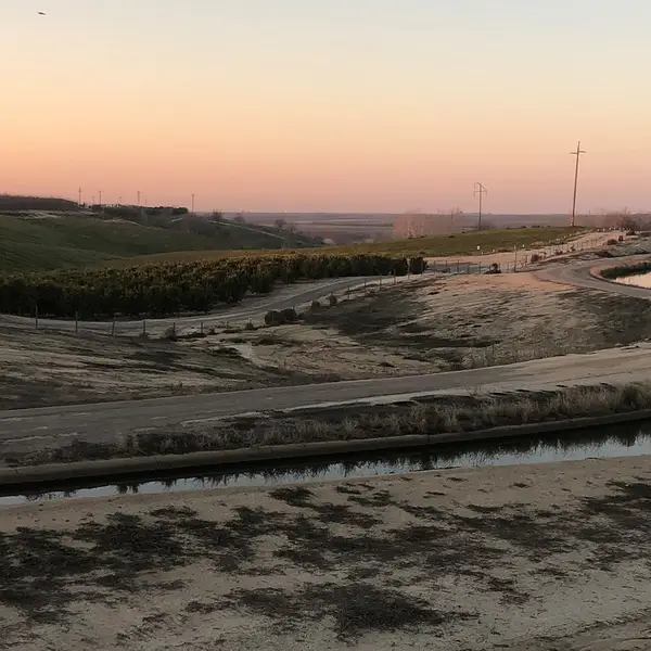 An irrigation canal brings water to the farmlands of California's Central Valley.