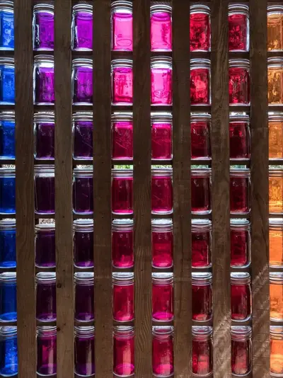 Wall of jars displaying an array of colorants