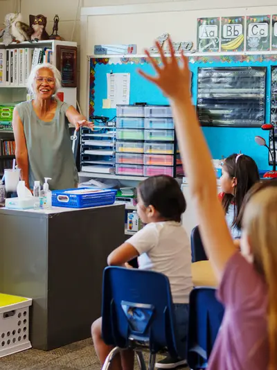 Student raising hand during class room