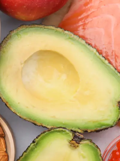 Blueberries, almonds, kiwi slice, avocado halves, salmon