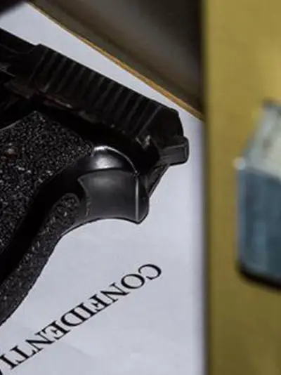 Gun in a safe. Safe door is partially open
