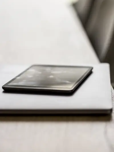 A laptop and a tablet sitting on a table