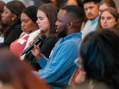 <p>PHield Trip participant asks a question (Photo: Adam Jennings, RTI International)</p>