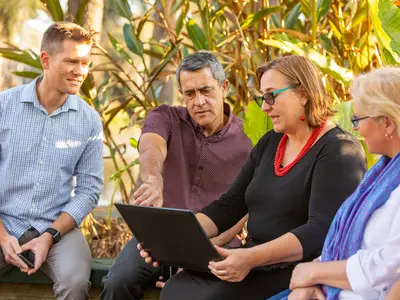 Group of people looks at computer