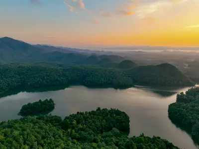 Aerial shot of a river and forested mountains