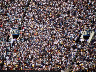 A large, tightly packed crowd of spectators at a stadium