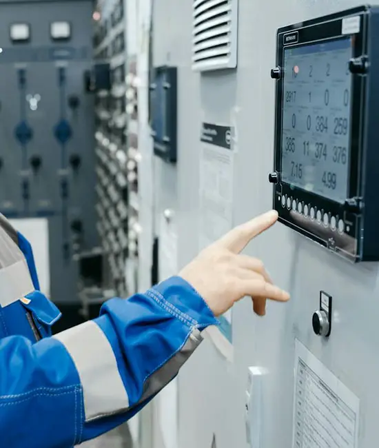 Industrial technician operating control panel. Photo by Sergey Sergeev