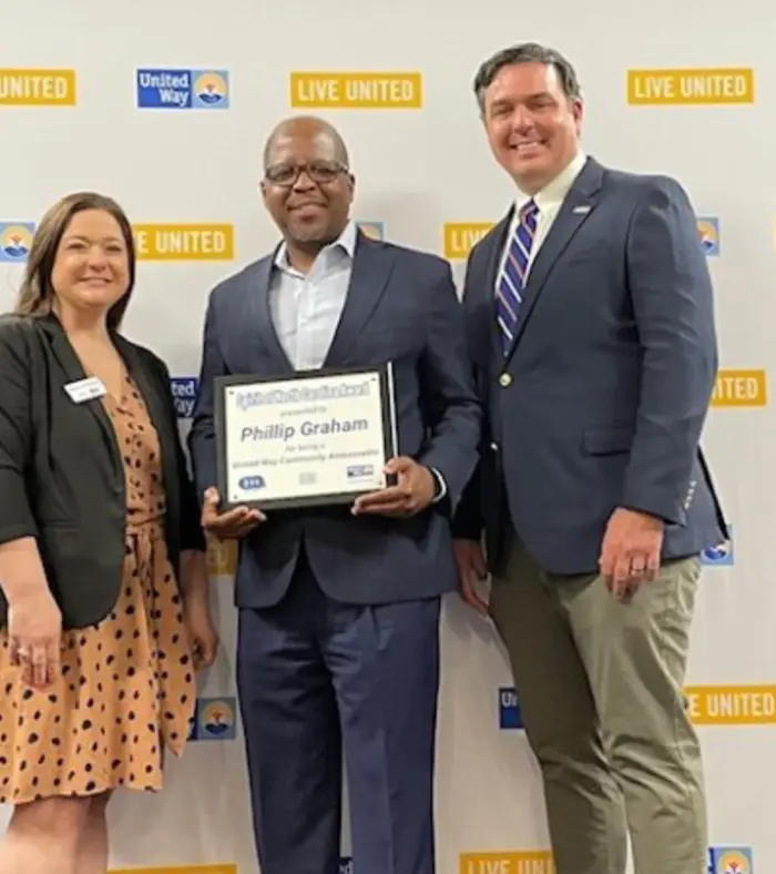 Phillip Graham holding the 2024 Spirit of NC Award United Way