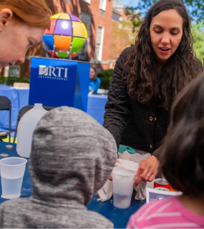Visitors at RTI's booth at the UNC Science Expo in April 2024