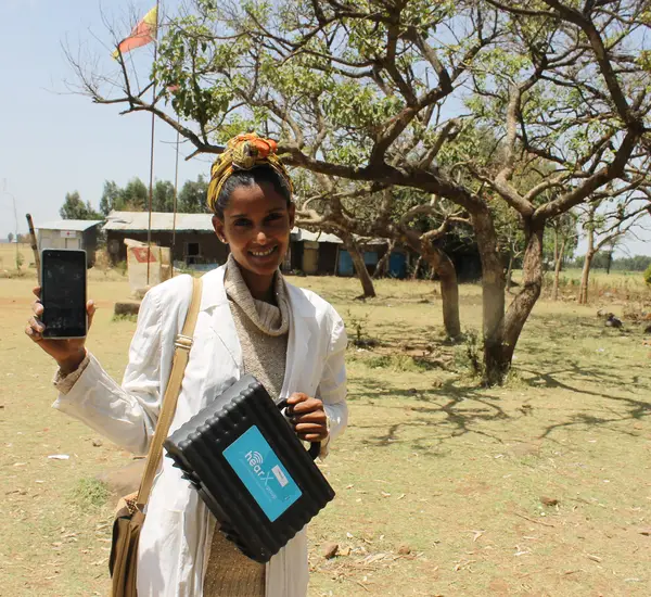 A teacher holds a phone used for hearing tests at a school in Ethiopia.