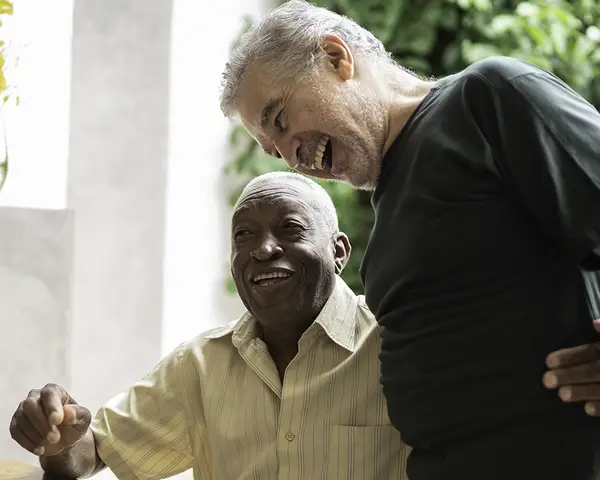 Two elderly men hugging