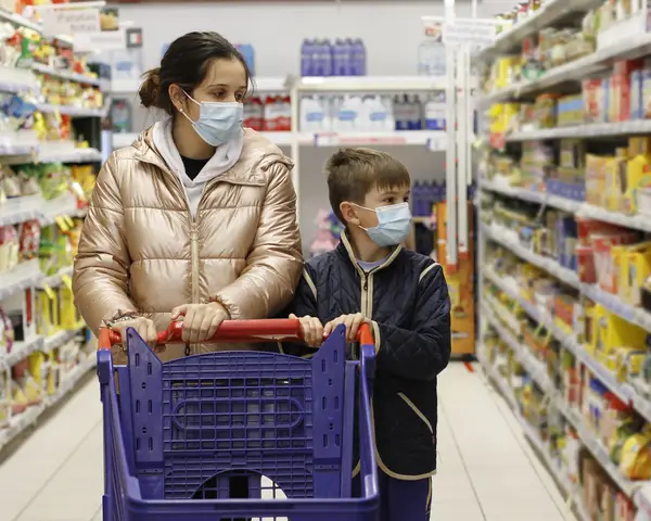 Mother and child wearing mask at the grocery store 