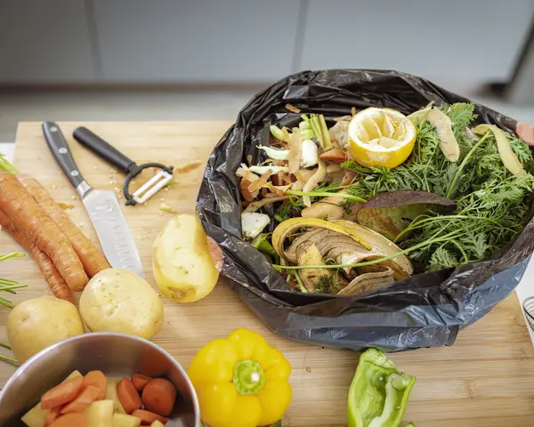 Food waste from vegetables in black trash bag