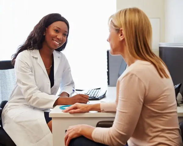 Patient Having Consultation With Female Doctor In Office