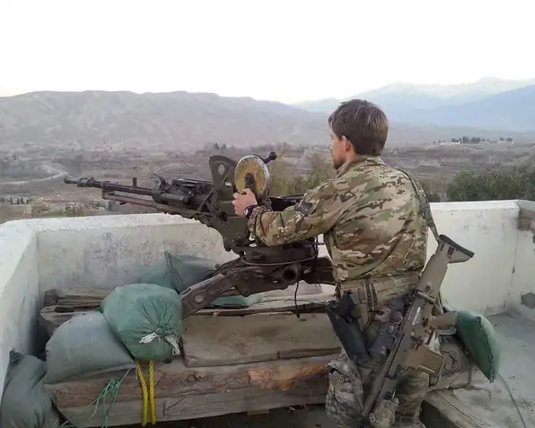 Troop pointing a machine gun