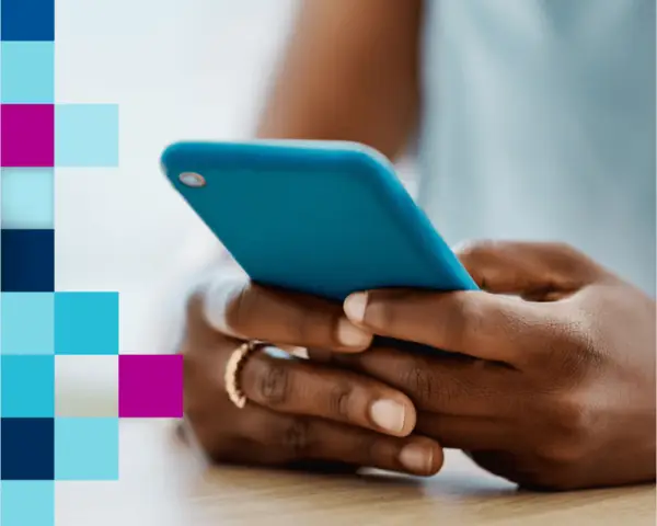 Hands holding a blue smartphone, with a colorful grid pattern on the left side.