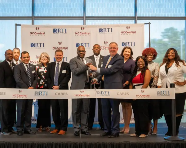 A group of people participate in a ribbon-cutting ceremony for NC Central University.