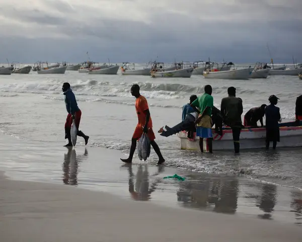 Women bring in a catch of fish in coastal Somalia.