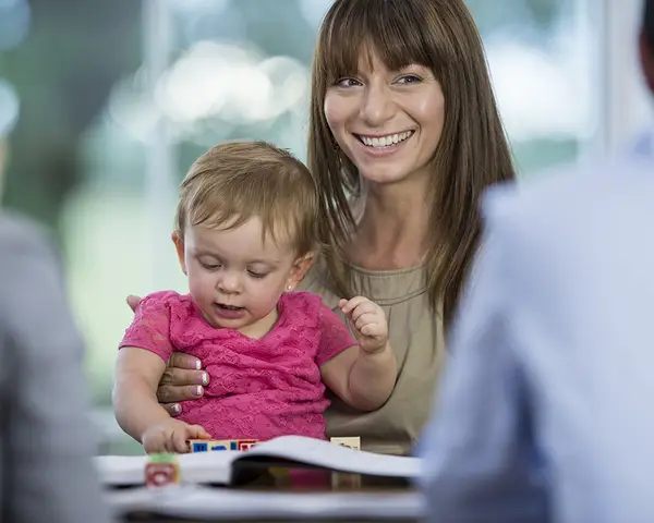 A mother brings her toddler to an appointment.