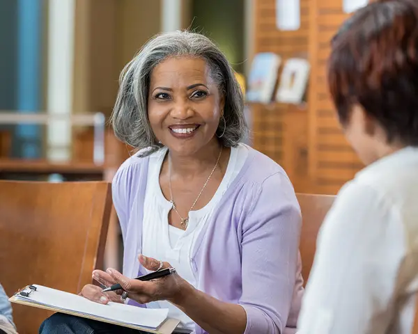 A Black female professor leads a book discussion.