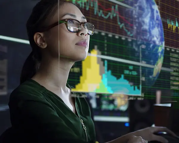 Woman reviews series of graphs and datasets.