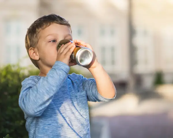 child drinking soda