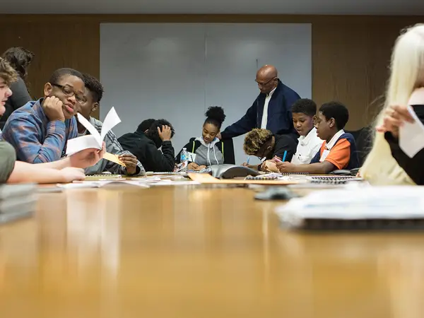 Students sit at a table for a discussion