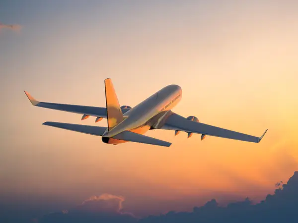 Plane flying with twilight backdrop