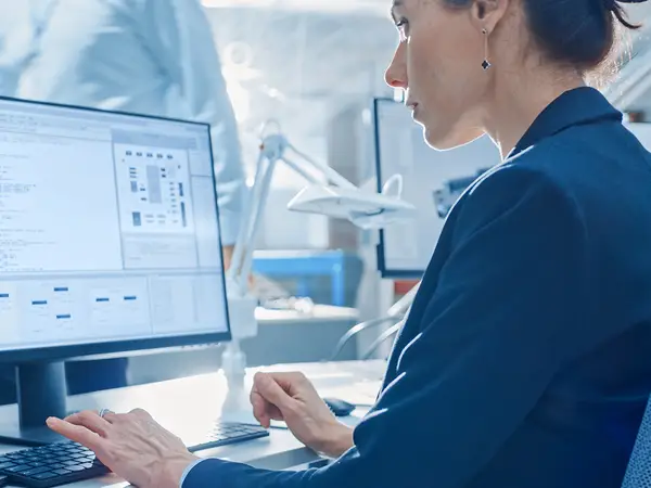 A researcher works on coding data at her computer.