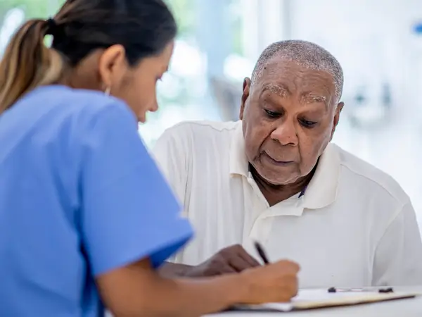 Doctor consults elderly patient