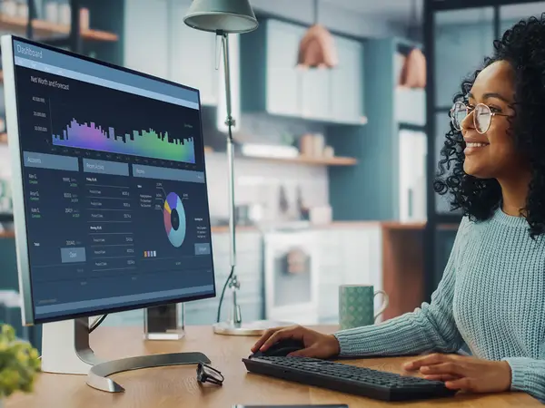 Woman working on a research project on a desktop computer at a desk